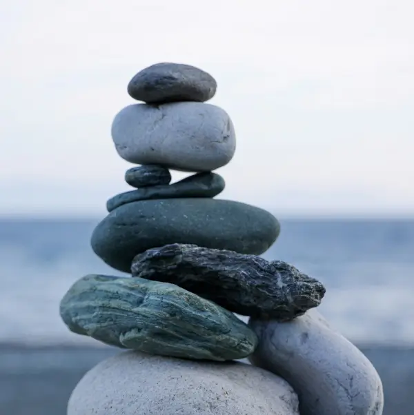 Rocks stacked on top of each other in front of an ocean